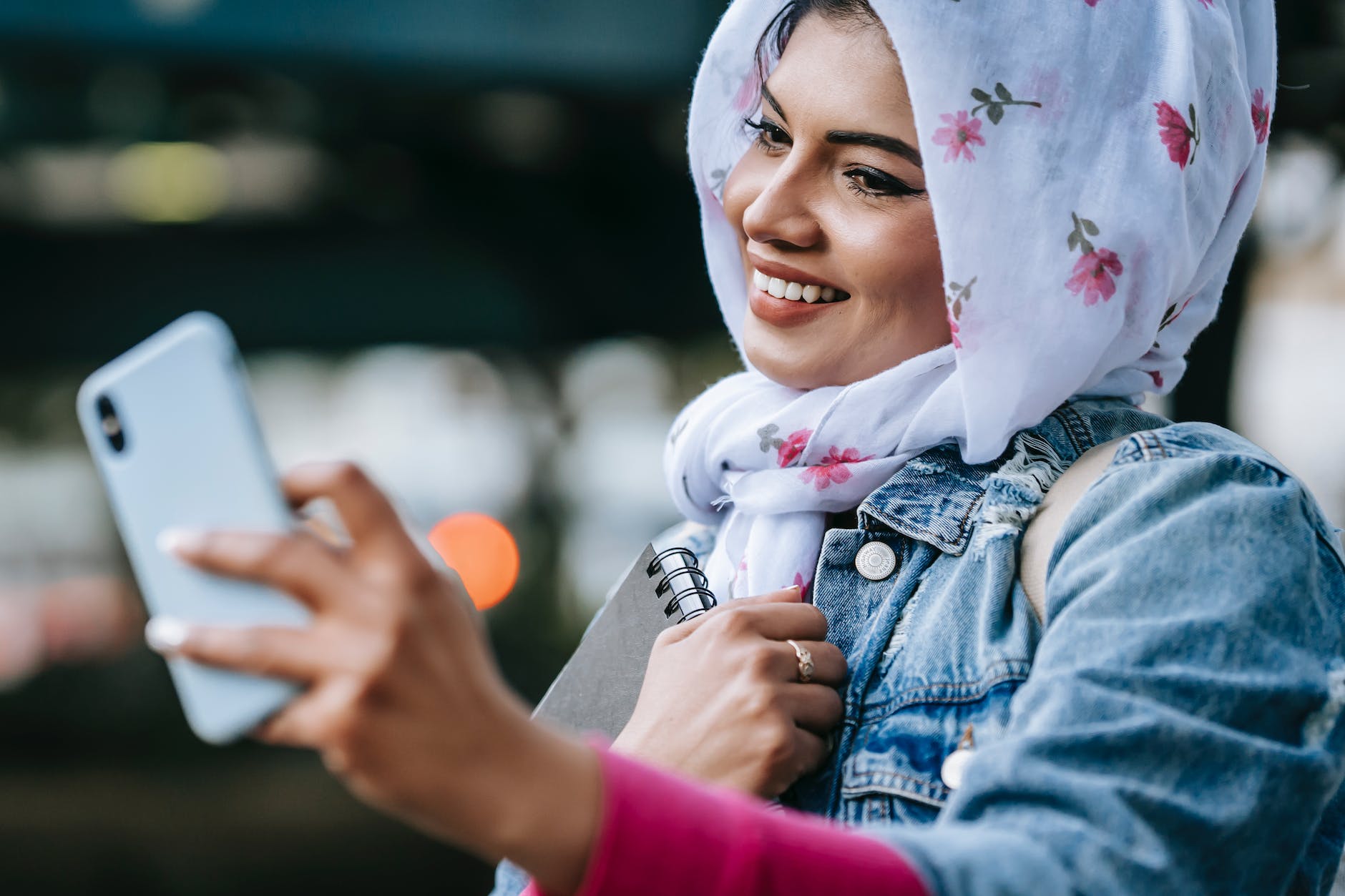connecting with your authentic self -- cheerful muslim woman taking selfie